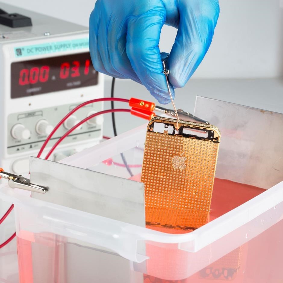 iPhone inside a plating tank, being electroplated in 24k gold solution