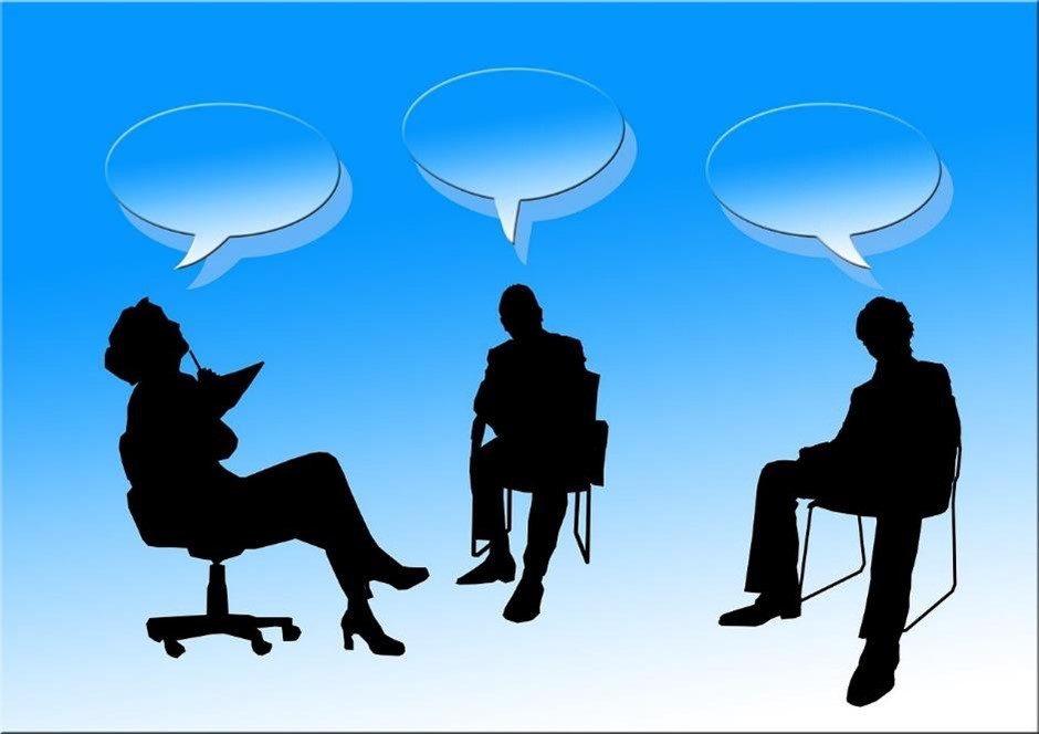 Cartoon image of three people sat in chairs, debating a topic