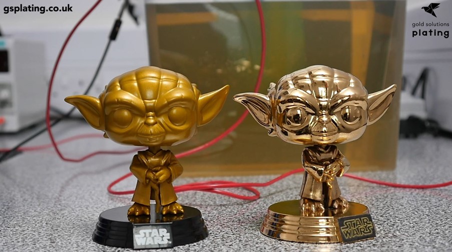 Plastic Star Wars figures placed side by side to show before and after metalising and gold plating